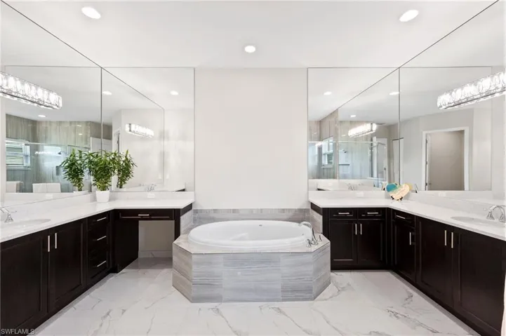 Bathroom with vanity and separate shower and tub