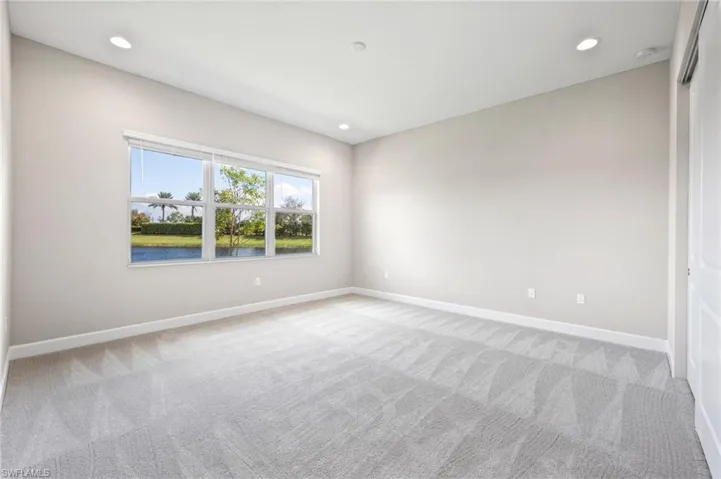 This bedroom with ensuite bath could double as a secondary primary suite.