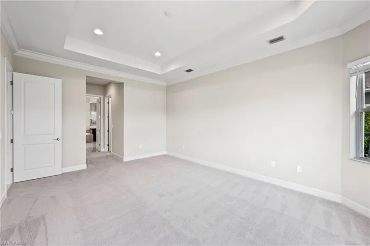 Large primary suite with eastern sunlight. Walk in closets on your left and right prior to the en-suite door.