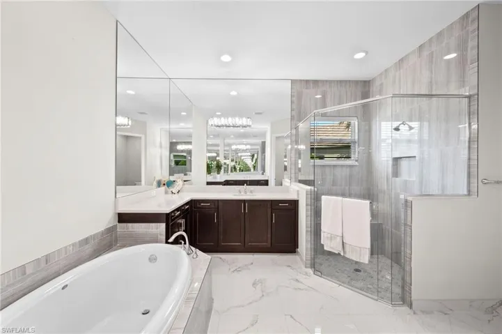 Bathroom featuring vanity and shower with separate bathtub
