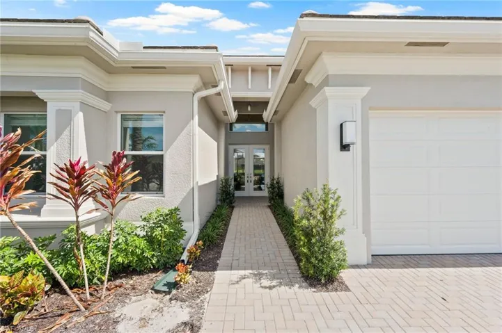Doorway to property featuring french doors and a garage