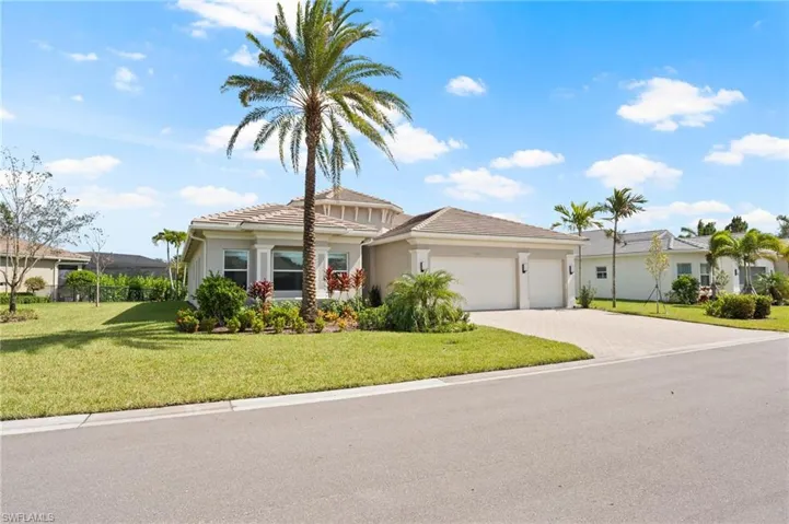 View of front of house with a front lawn and a garage
