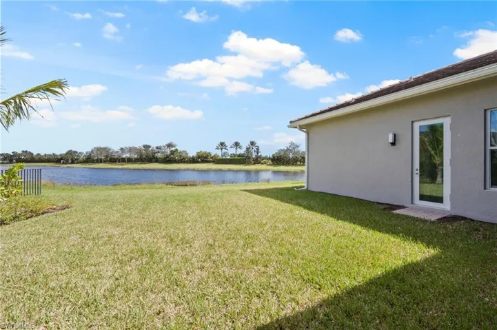 View of your private yard with a lake view over landscaping