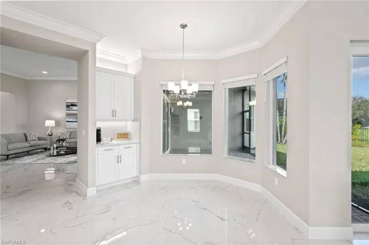 Unfurnished dining area featuring ornamental molding and a chandelier