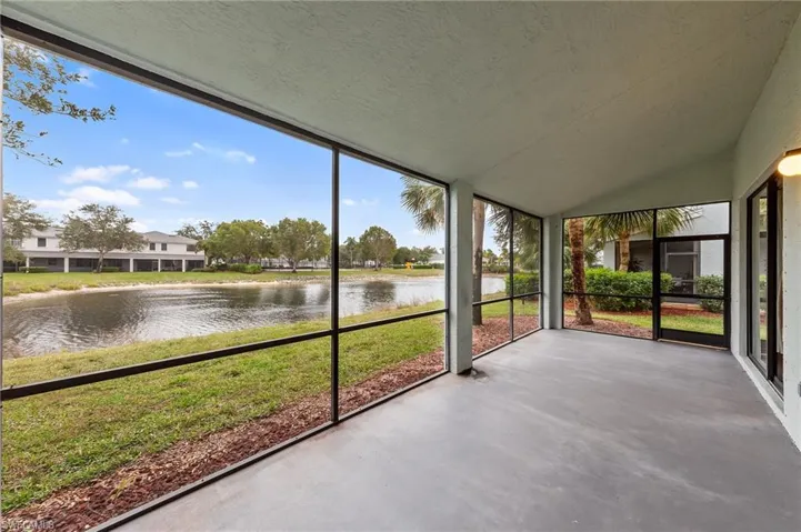 Unfurnished sunroom with a water view and lofted ceiling