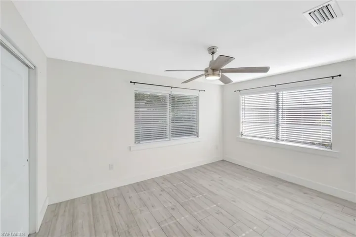 Empty room with light wood-type flooring and a ceiling fan