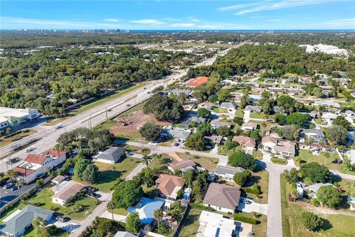 Aerial view of property and surrounding area with nearby suburban area