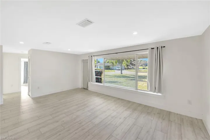 Spare room with light wood-style floors and recessed lighting