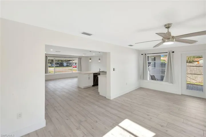Empty room featuring light wood-type flooring and ceiling fan