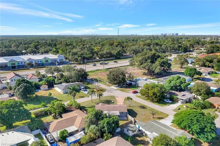 Aerial perspective of suburban area featuring a heavily wooded area