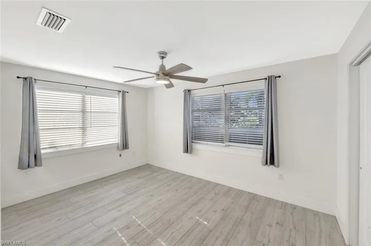 Spare room featuring light wood-style flooring and a ceiling fan