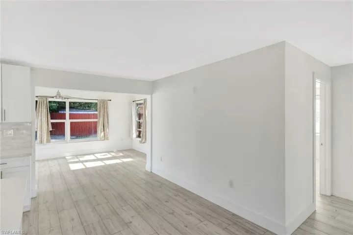 Spare room featuring light wood finished floors and baseboards