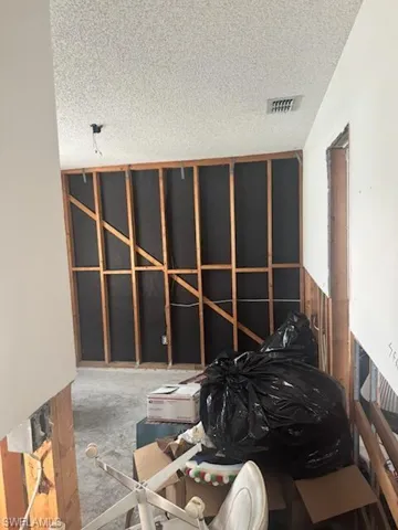 Misc room with a textured ceiling