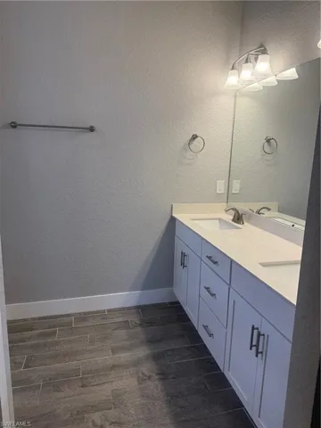 Bathroom featuring vanity and wood-type flooring