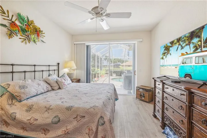 Bedroom featuring ceiling fan, light wood-type flooring, and access to outside