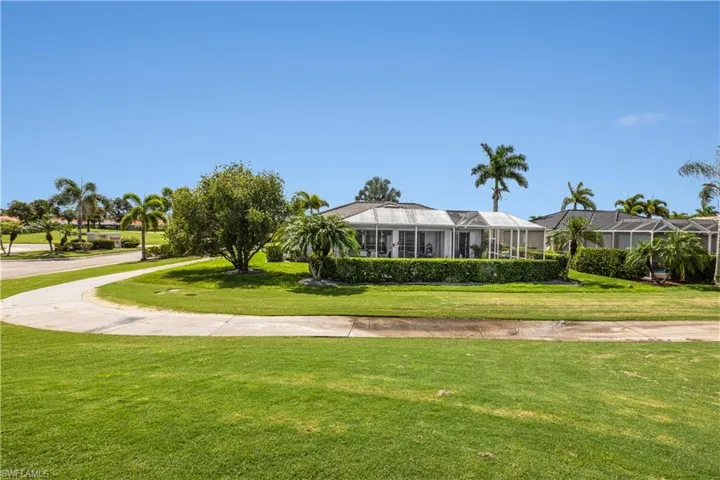 View of property's community with a lawn