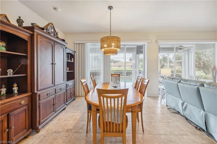 Dining room featuring a healthy amount of sunlight, light tile patterned floors, and ceiling fan