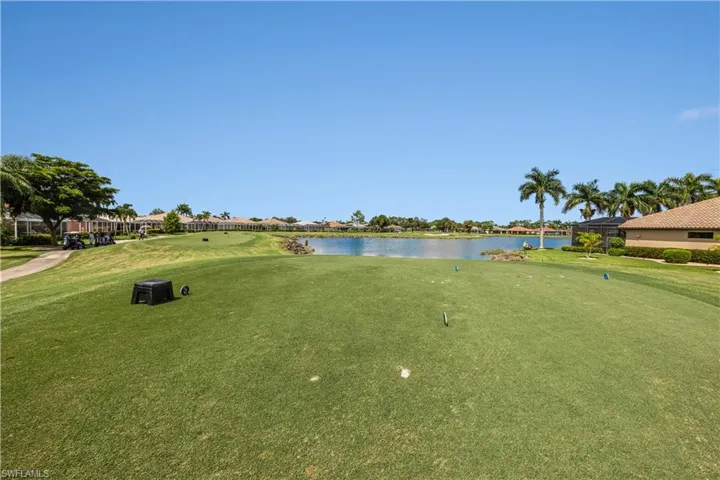 View of community featuring a yard and a water view