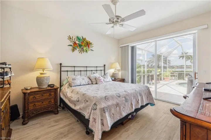Bedroom with access to exterior, ceiling fan, and light hardwood / wood-style flooring