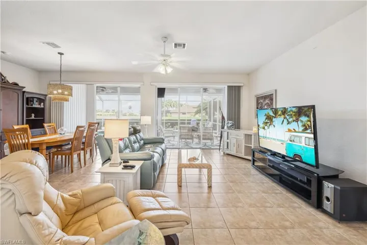Living room featuring ceiling fan and light tile patterned floors