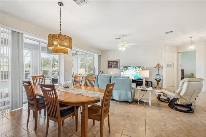 Dining space featuring ceiling fan and light tile patterned floors