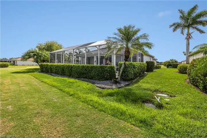 View of yard featuring glass enclosure