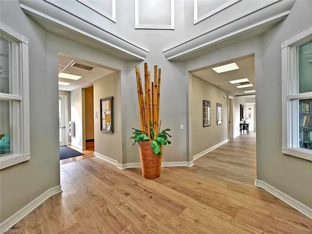 Hall with light wood-style flooring and baseboards