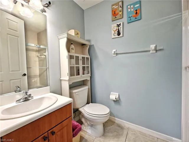 Bathroom featuring vanity, a shower, and tile patterned flooring