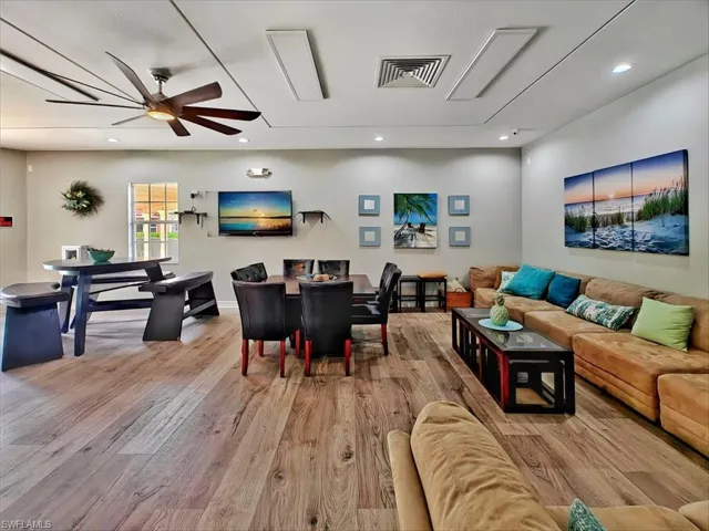 Living room featuring recessed lighting, a ceiling fan, and wood finished floors