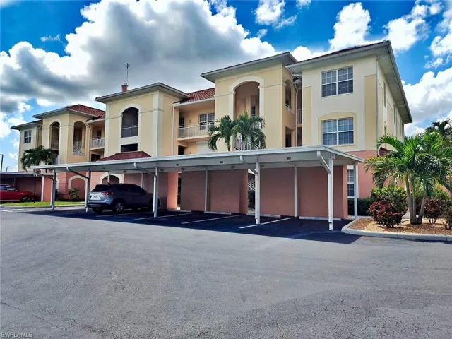 View of building exterior with covered parking