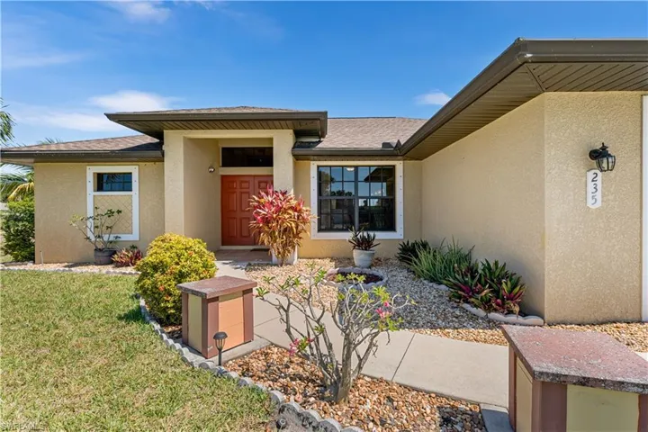 View of exterior entry with a lawn