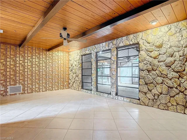 Tiled dining room with beamed ceiling, wood ceiling, and wooden walls