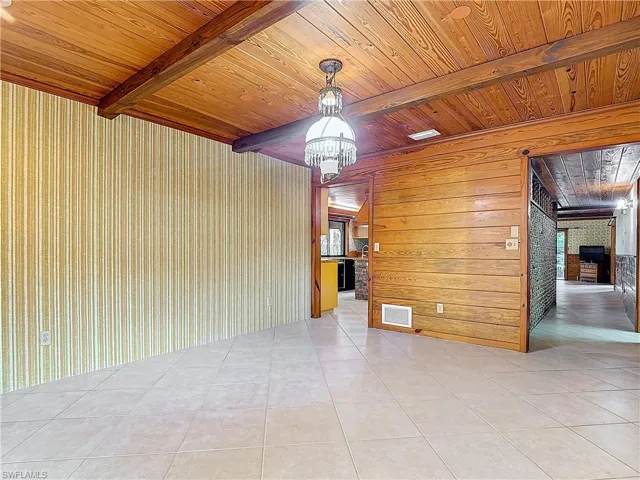 Laundry room featuring tile patterned floors, dual sinks, and a healthy amount of sunlight