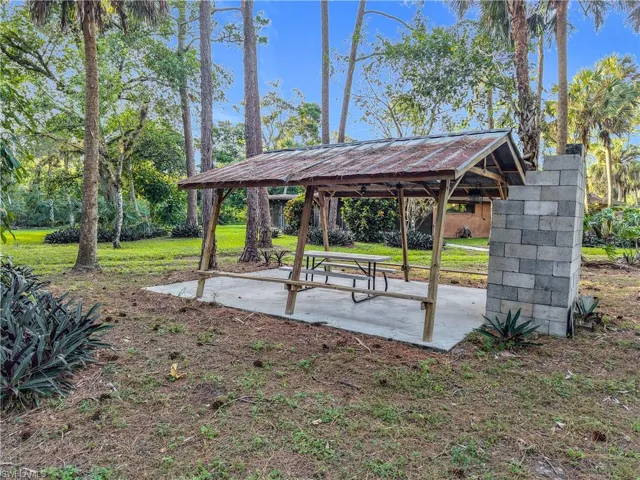Unfurnished sunroom with ceiling fan and wood ceiling