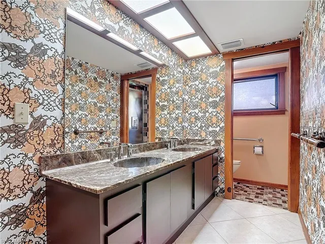 Tiled Master Bedroom with wood walls and ceiling fan