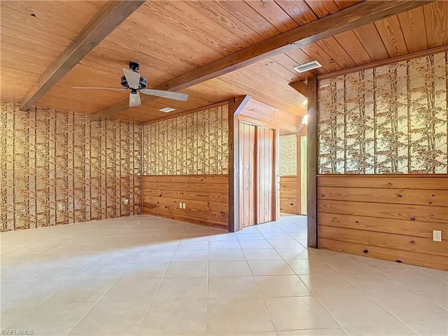 Tiled Parlor room featuring beam ceiling, ceiling fan, and wooden ceiling