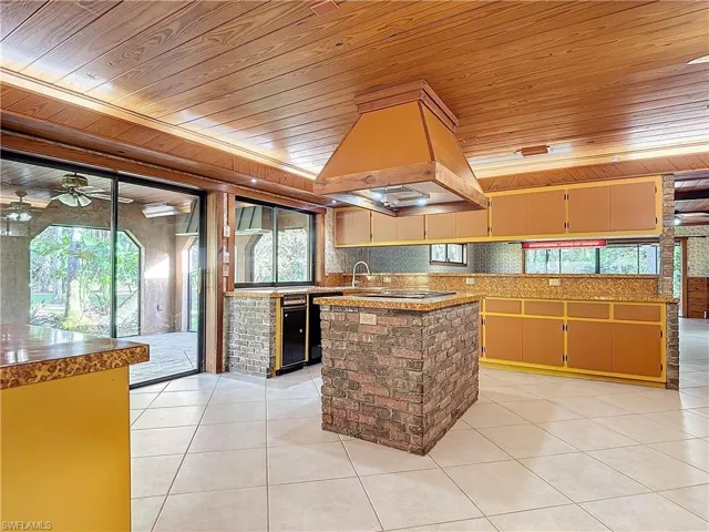 Living room featuring wood walls, wood ceiling, beam ceiling, and pool table