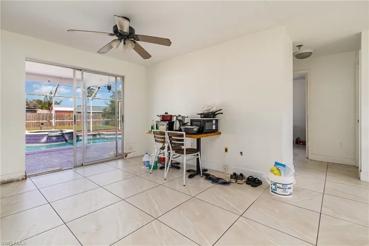 Office area featuring a ceiling fan, tile patterned flooring, and baseboards