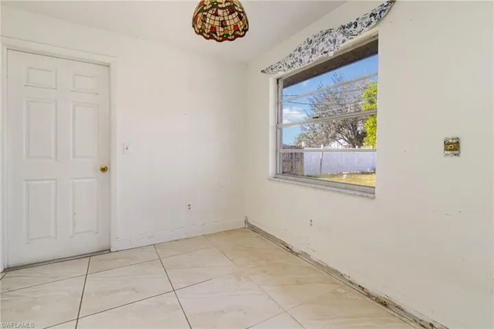 Spare room featuring baseboards