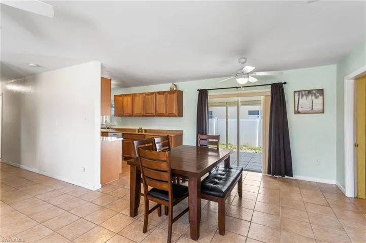 Dining room with ceiling fan and light tile patterned flooring