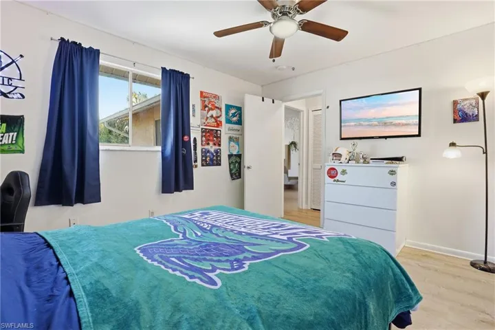 Bedroom with a ceiling fan and light wood-style floors