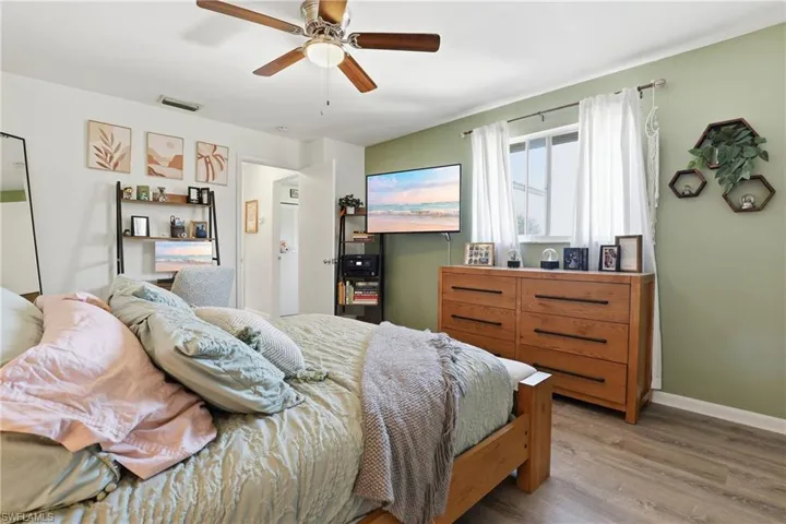 Bedroom featuring wood finished floors and ceiling fan