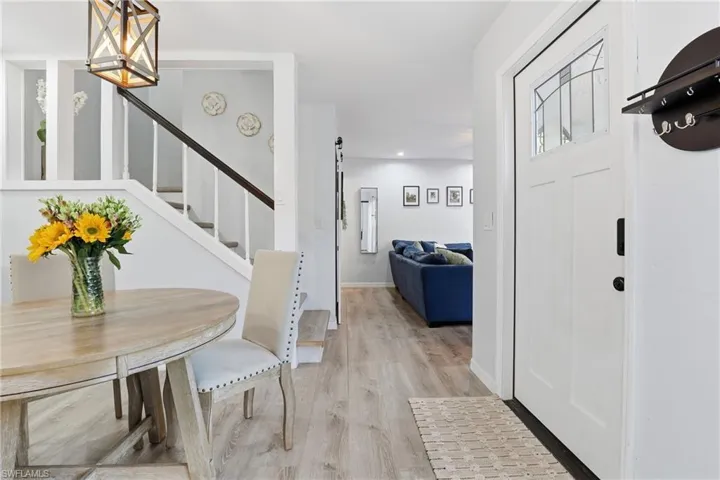 Foyer with light wood finished floors and stairs