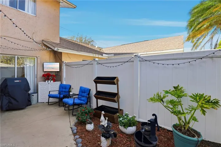 Fenced backyard featuring a patio and area for grilling