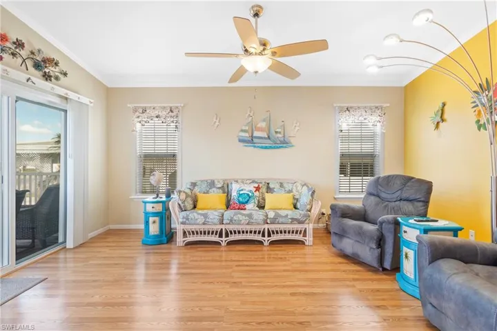 Living room with light hardwood / wood-style floors, and ceiling fan