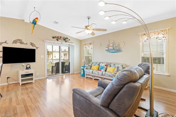 Living room featuring lofted ceiling, light hardwood / wood-style floors, and plenty of natural light