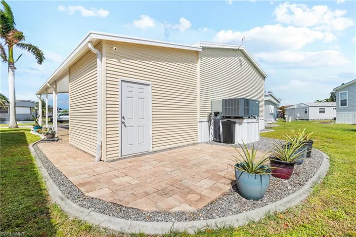 View of outbuilding with a lawn