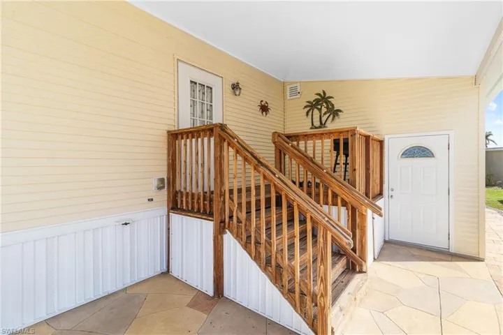 Staircase featuring vaulted ceiling