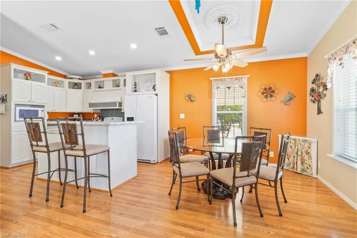Kitchen and Dining room with light hardwood / wood-style flooring and a healthy amount of sunlight