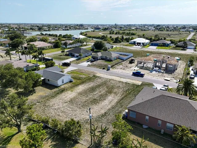 Aerial perspective of suburban area featuring a large body of water